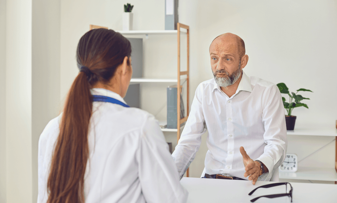 Concerned patient discussing symptoms with a neurologist, highlighting the importance of early diagnosis in functional neurological disorder (FND).