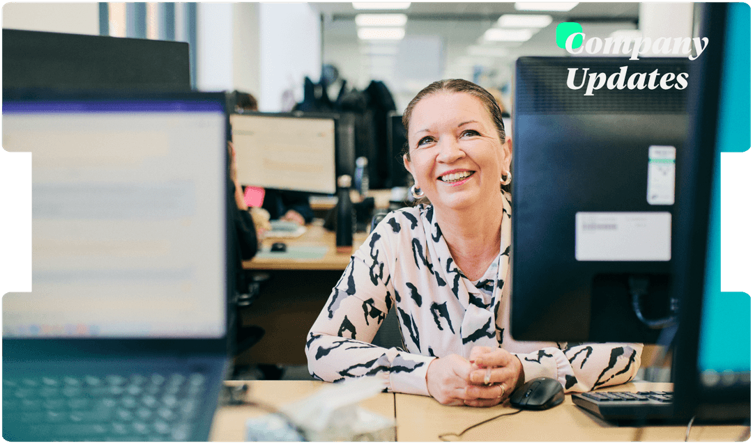 Smiling team member works at her desk in a busy office, reflecting INNEG’s supportive culture and commitment to efficient claims handling.