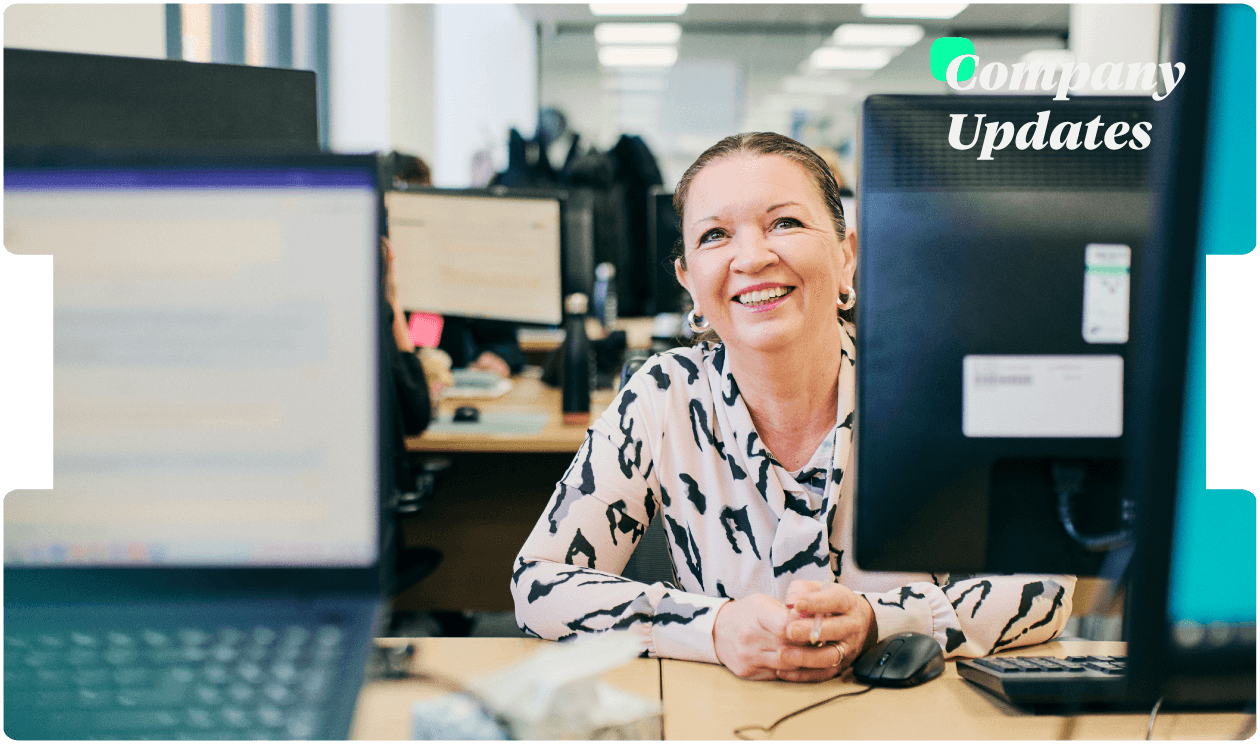 Smiling team member works at her desk in a busy office, reflecting INNEG’s supportive culture and commitment to efficient claims handling.