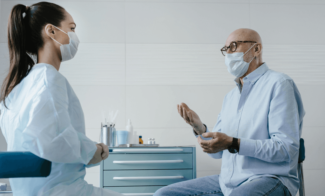 Doctor listening to a patient during consultation, highlighting the strain on cancer services and rising litigation concerns after COVID-19.