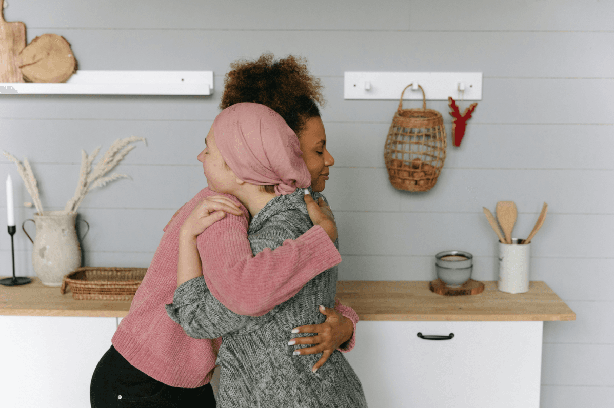 cancer image, hugging, two women