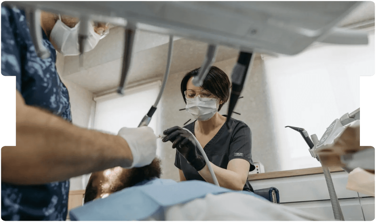 Dentists performing a procedure on a patient, highlighting key considerations for solicitors handling dental personal injury claims.