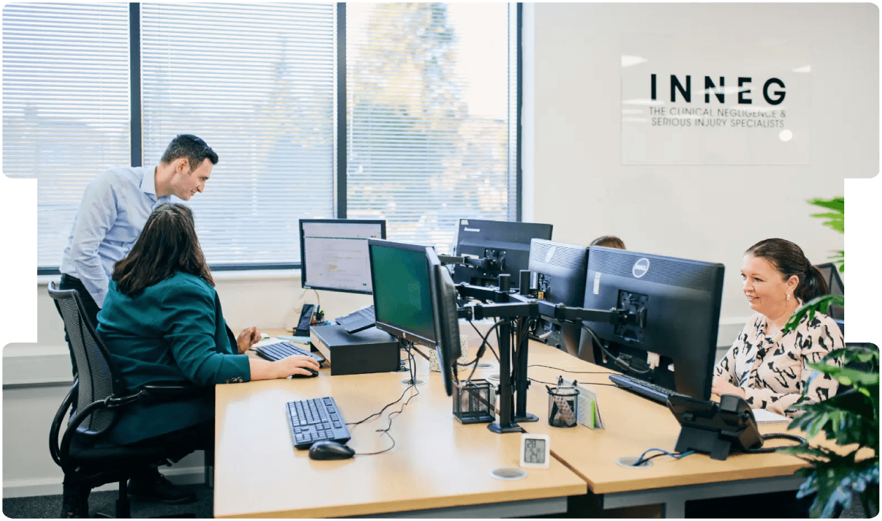 INNEG team collaborating in a modern office, showcasing professionalism and expertise in sourcing high-calibre medico-legal expert witnesses.