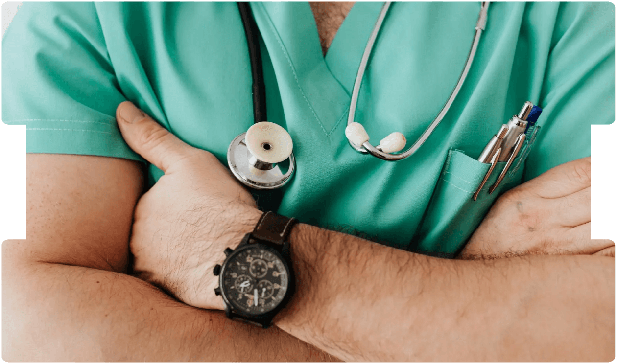 Doctor in scrubs with arms crossed, representing healthcare costs and medical service expenses.