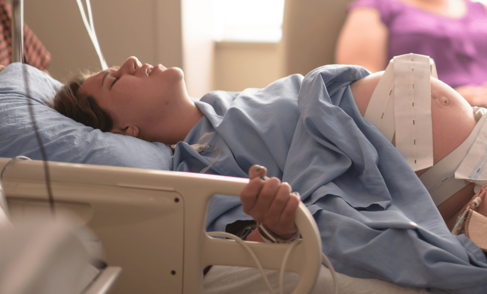 Woman in labour monitored in hospital, illustrating the challenges and medico-legal considerations of managing breech delivery cases.