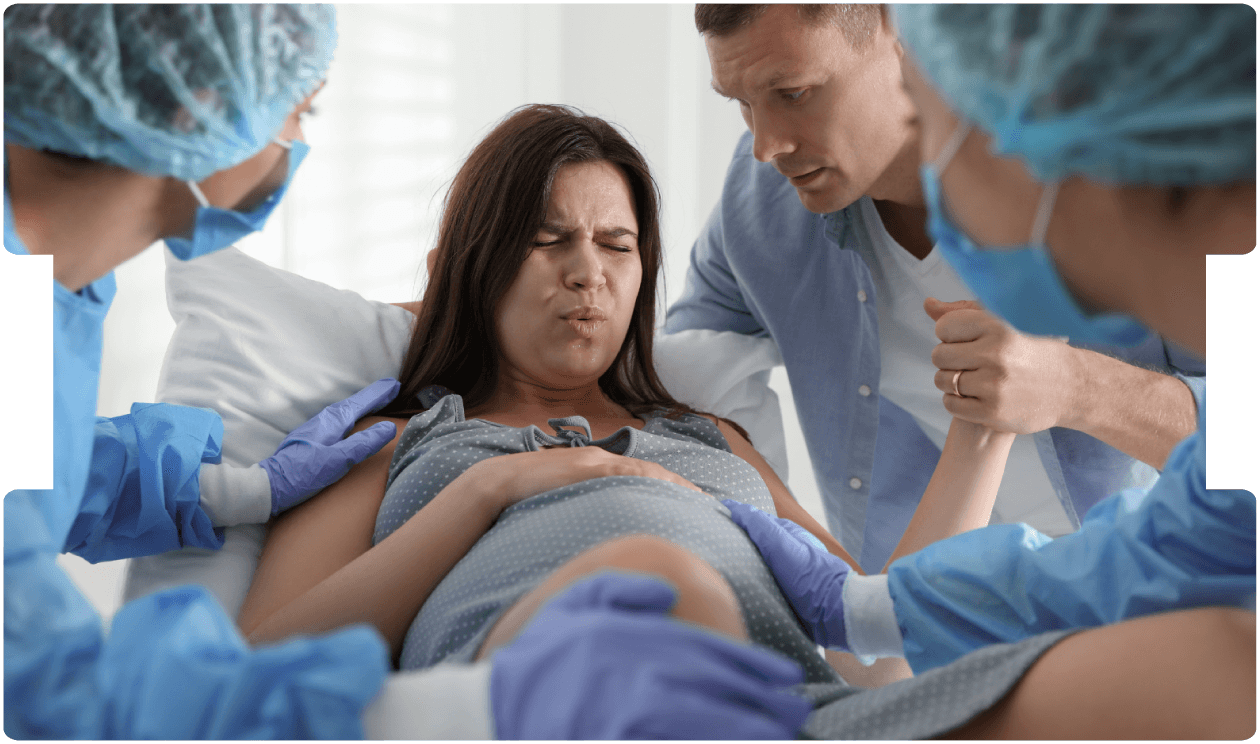 A woman in labor supported by her partner and medical team during childbirth, showing care, strength, and maternity support.