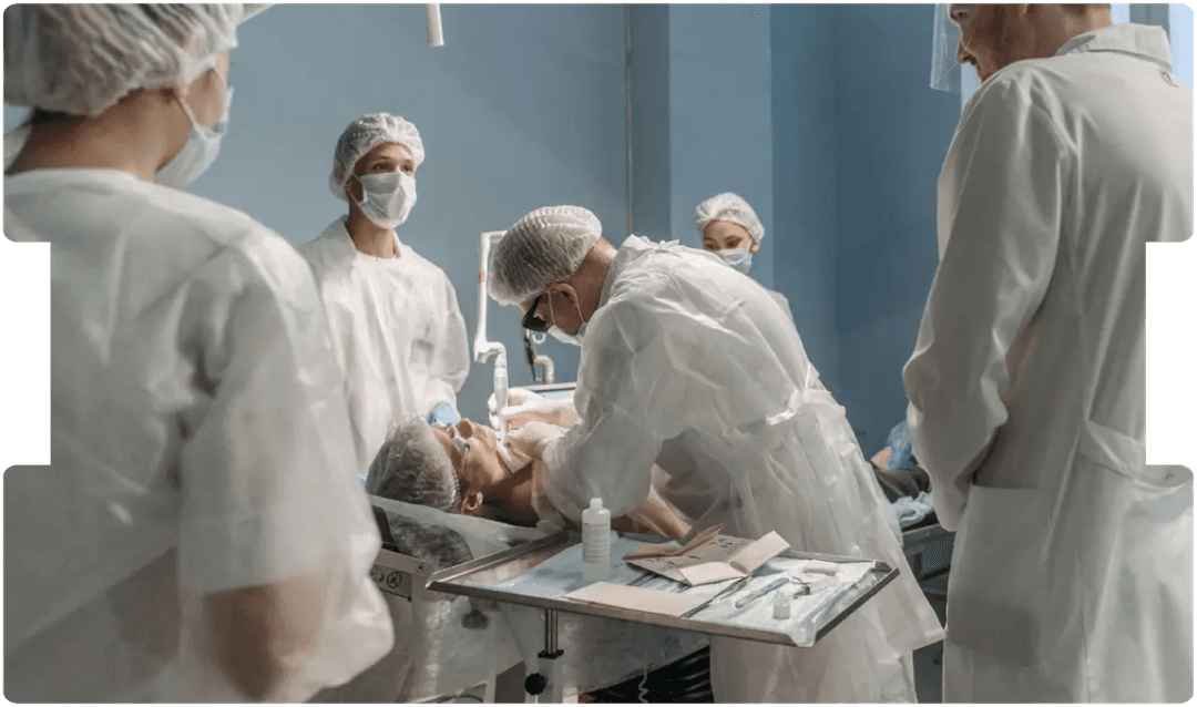 Medical team performing a procedure in theatre, emphasising training and precision to prevent misplaced nasogastric tubes, a serious never event.