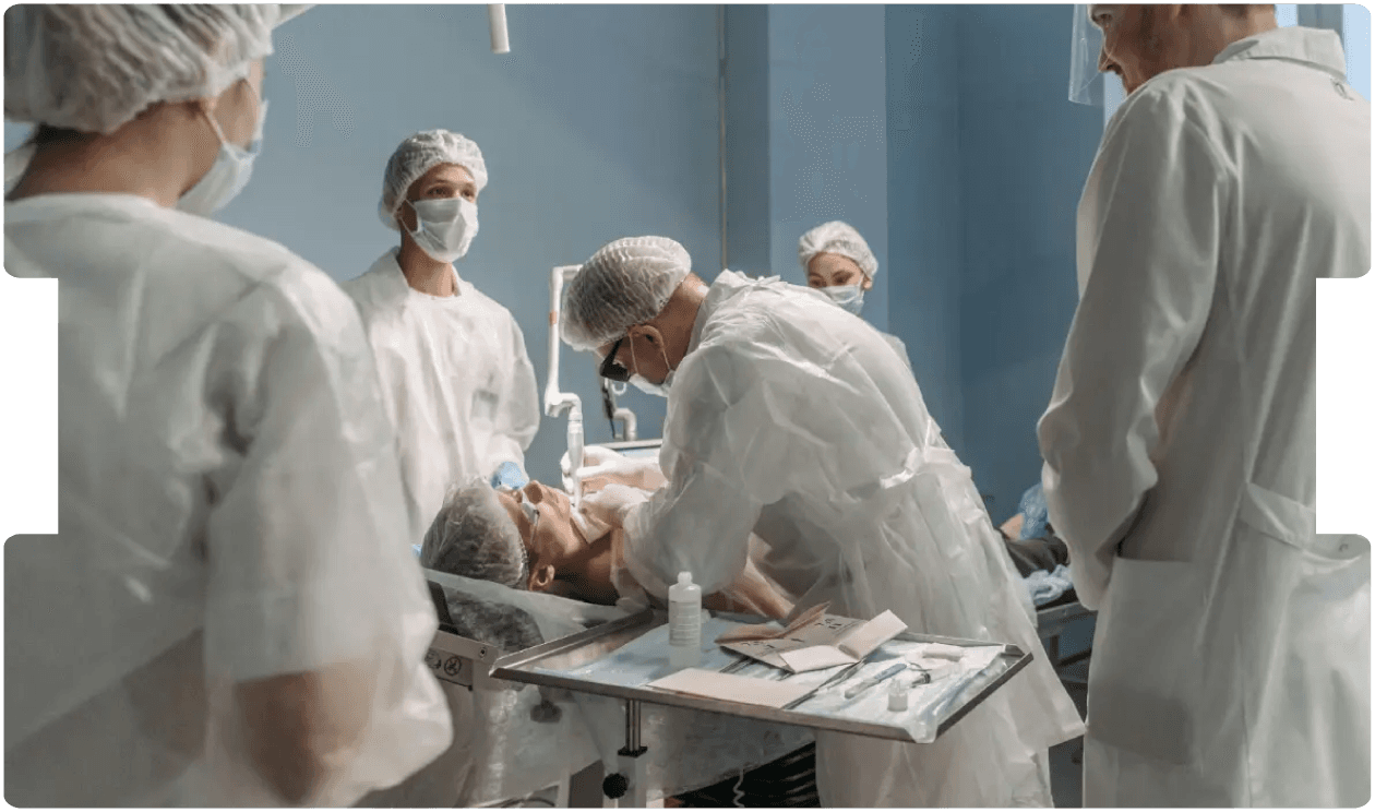 Medical team performing a procedure in theatre, emphasising training and precision to prevent misplaced nasogastric tubes, a serious never event.