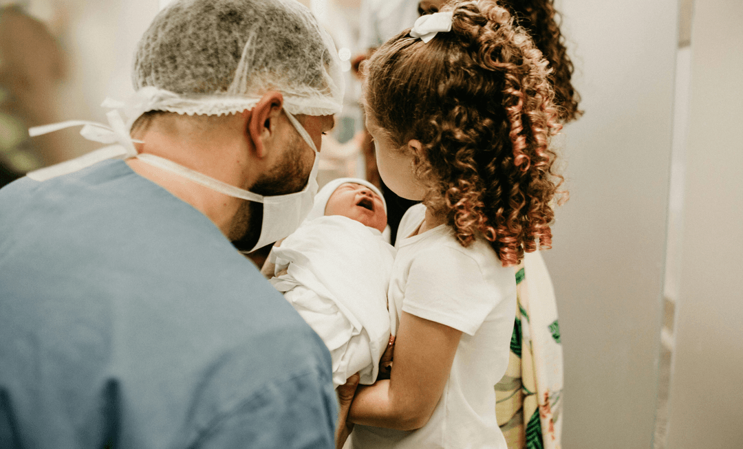 Doctor and child meeting a newborn baby, symbolising the early-life challenges and medico-legal implications of perinatal stroke.