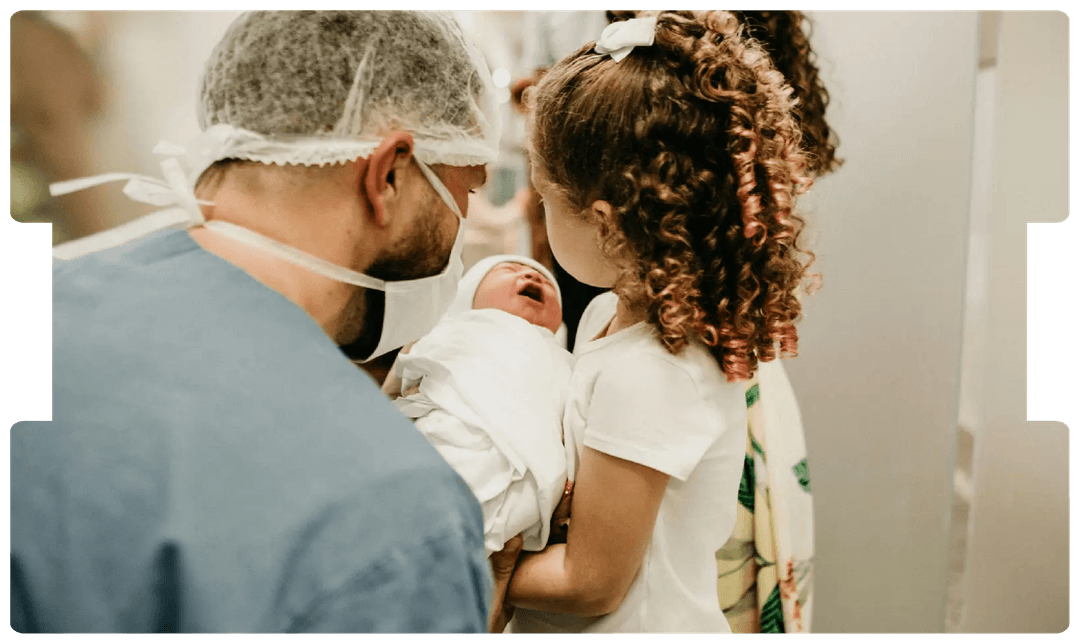 Doctor and child meeting a newborn baby, symbolising the early-life challenges and medico-legal implications of perinatal stroke.