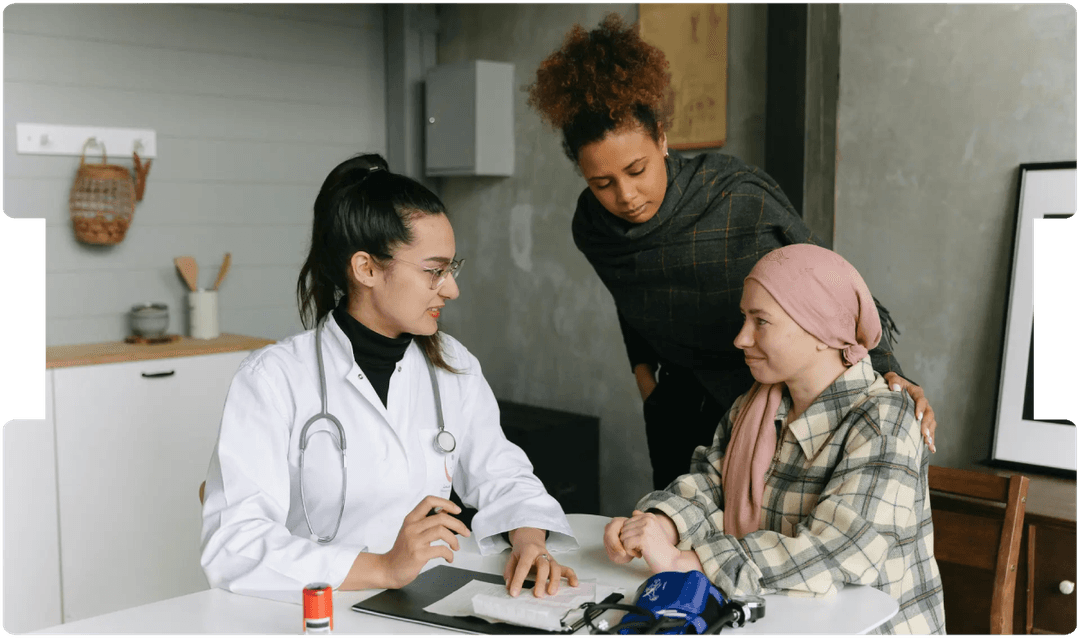 Doctor consulting a patient with a supportive companion, reflecting the emotional and legal challenges of delayed sarcoma diagnosis and treatment.