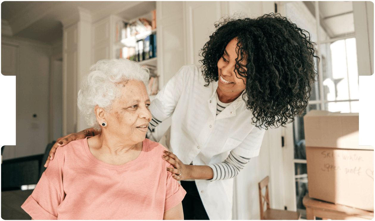 Carer supports an older woman at home, promoting compassionate stroke recovery care and personalised rehabilitation guidance.