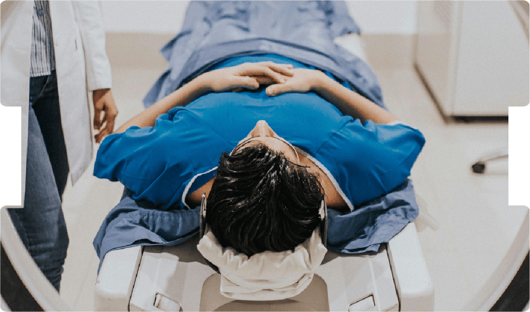 Patient lying in MRI scanner with clinician nearby, highlighting diagnostic imaging, medical assessment, and expert witness work.