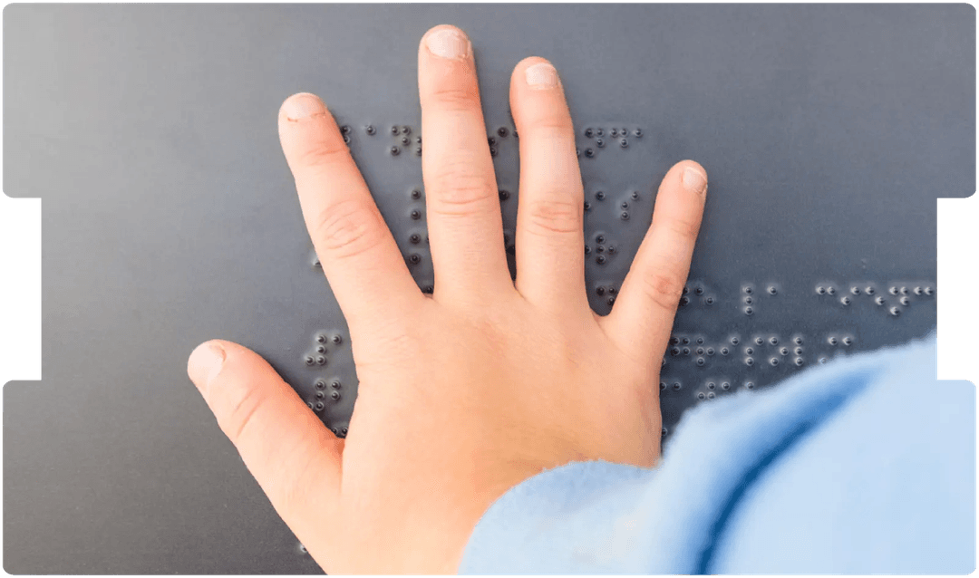 Child’s hand reading Braille, representing visual impairment and support for paediatric cortical visual impairment (CVI).