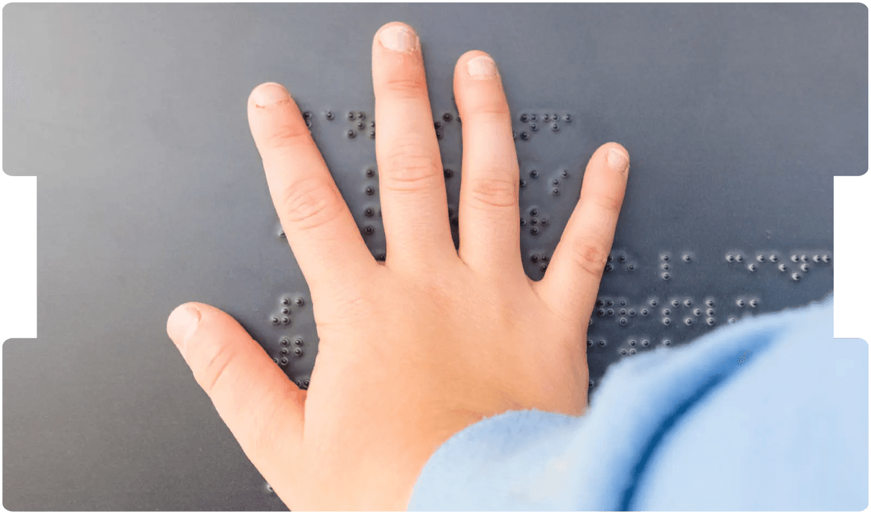 Child’s hand reading Braille, representing visual impairment and support for paediatric cortical visual impairment (CVI).
