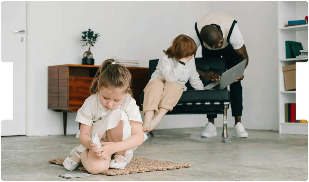 Young girl playing while adults work nearby, symbolising awareness of autism, trauma, and neurodivergence in personal injury assessments.