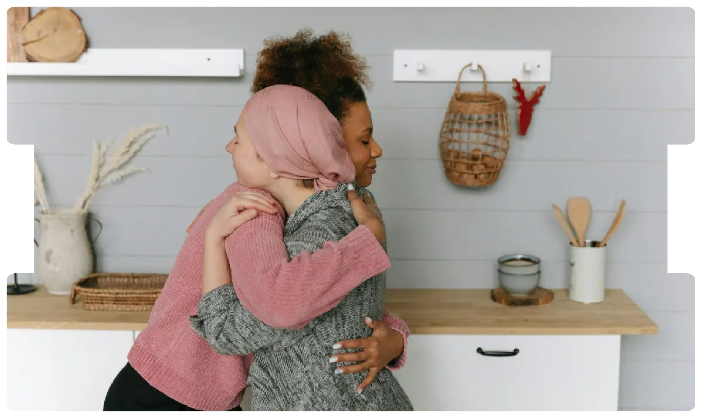 Woman wearing a headscarf hugging a friend in support, symbolising the emotional impact and challenges of late colorectal cancer diagnosis.