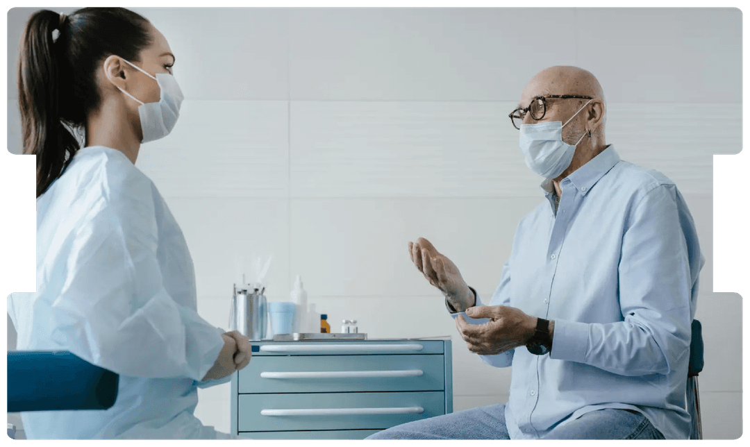 Doctor listening to a patient during consultation, highlighting the strain on cancer services and rising litigation concerns after COVID-19.