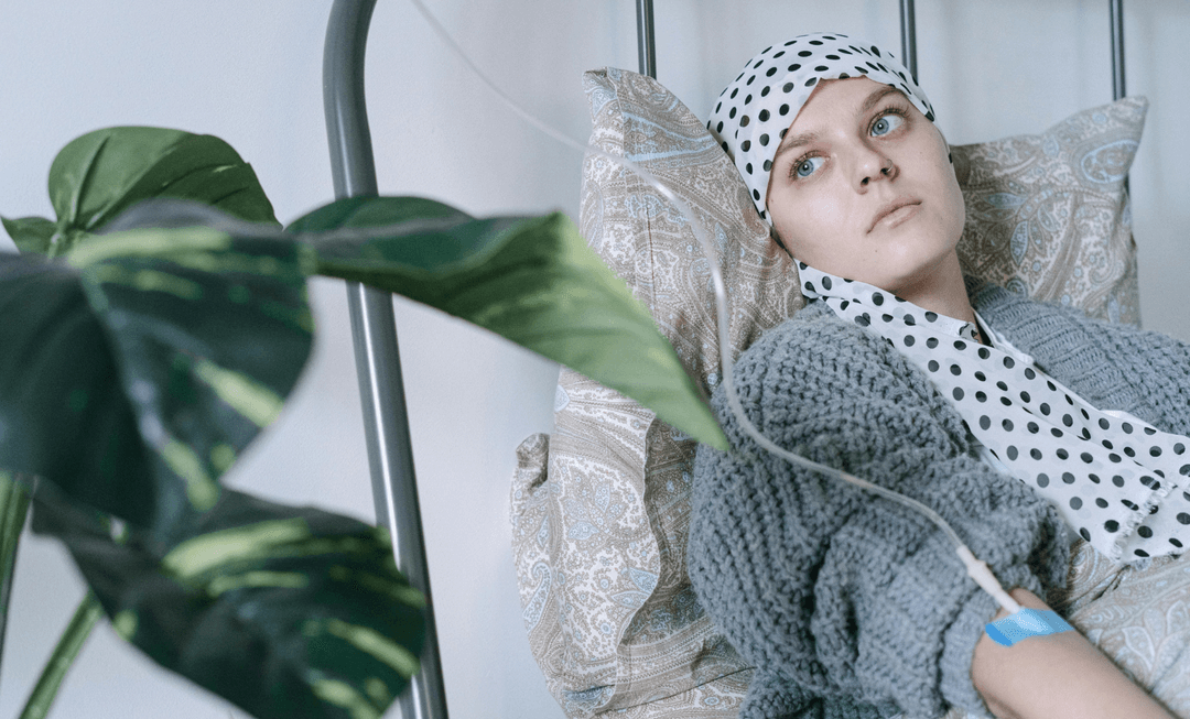Woman undergoing IV treatment while resting, reflecting the disruption and challenges faced by cancer patients during the COVID-19 pandemic.