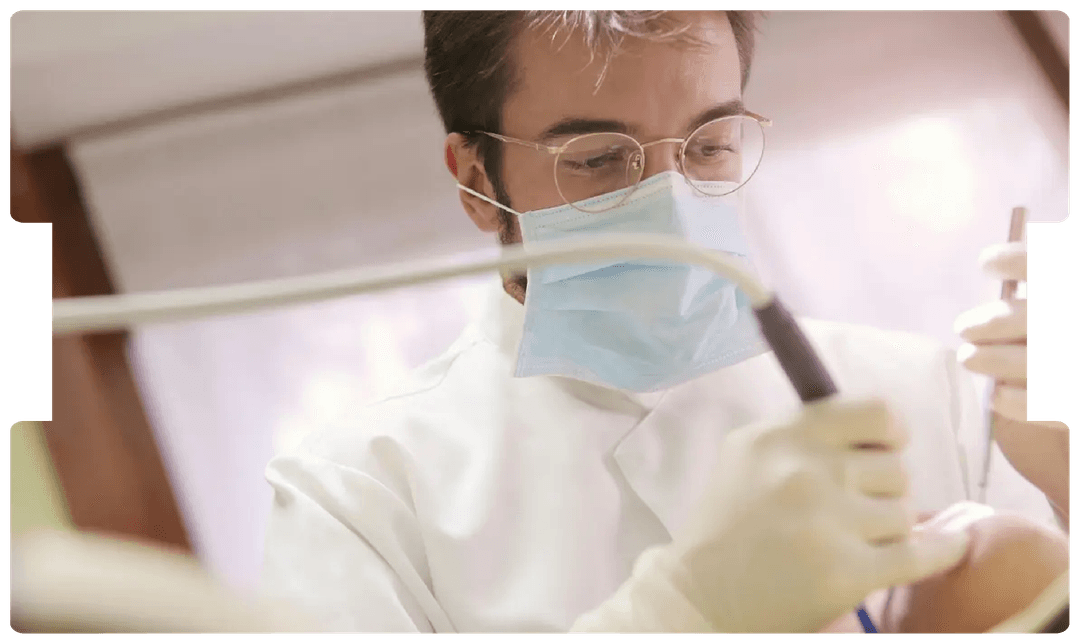 Dentist performing a procedure with precision tools, representing the expertise and guidance required when instructing a dental expert witness.