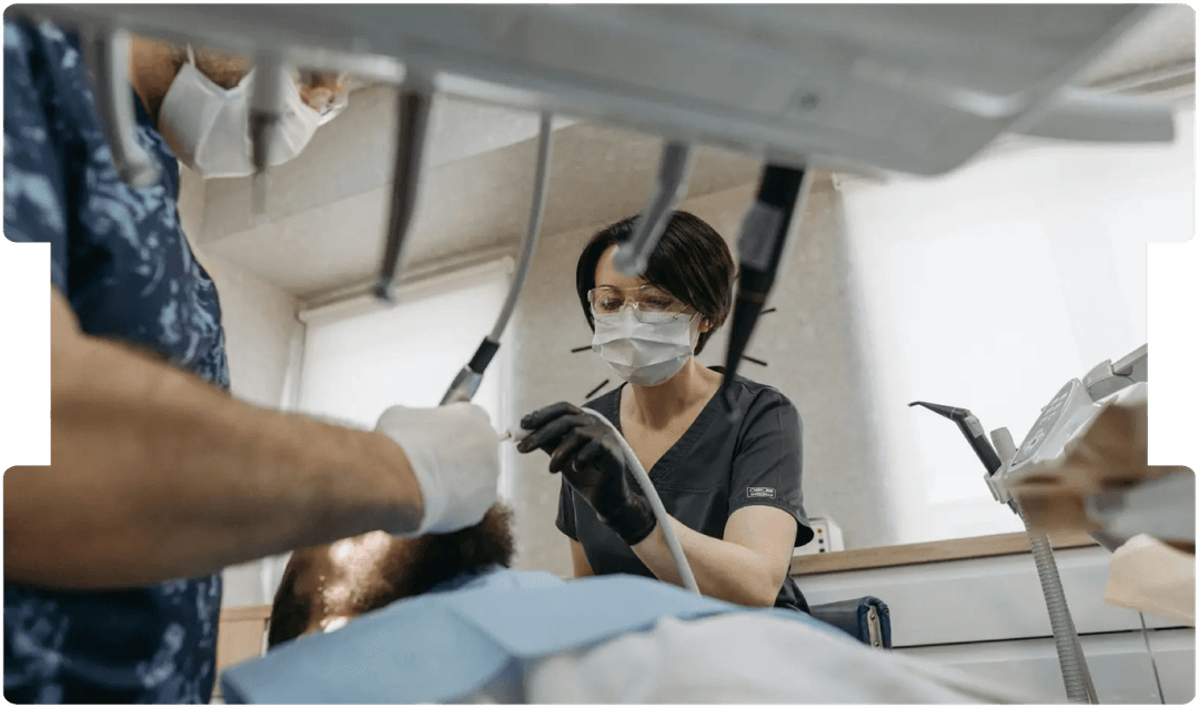 Dentists performing a procedure on a patient, highlighting key considerations for solicitors handling dental personal injury claims.