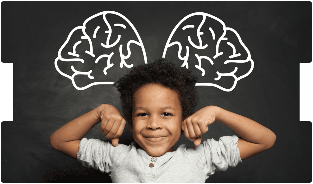 Smiling child flexing arms in front of a chalkboard with brain drawings, symbolizing recovery and strength after paediatric traumatic brain injury.