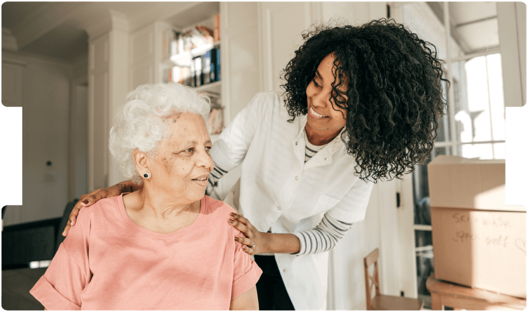 Carer supports an older woman at home, promoting compassionate stroke recovery care and personalised rehabilitation guidance.
