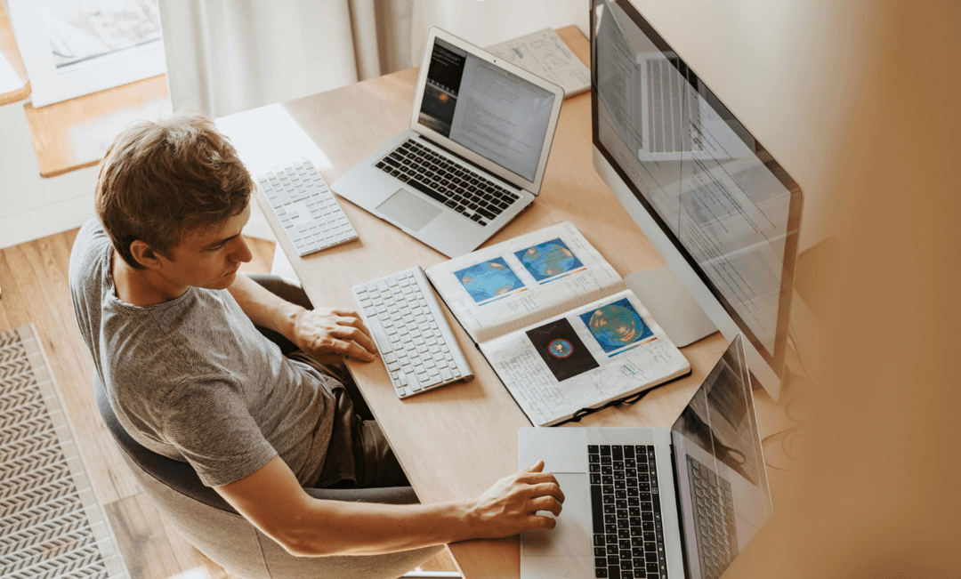 Smiling doctor using a smartphone and laptop, representing the growing role and medico-legal considerations of virtual medical consultations.